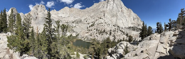 Panoramic view of Mirror Lake surrounded by granite peaks and forest, taken from the Mount Whitney Main Trail.