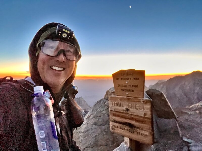 Jeff excitedly reaches Trail Crest, standing above the 99 switchbacks at 13,645 feet in the pre-dawn glow. The iconic sign marking the highest trail pass in the United States.
