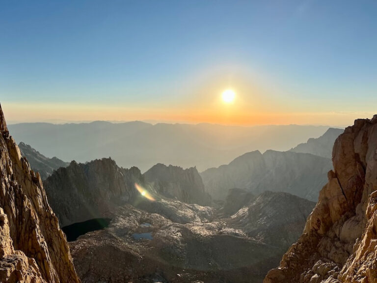 A view through the iconic windows on the Mount Whitney Trail as the morning sun casts a warm glow over the Owens Valley. The west side remains shaded, making the sunlight a welcome, fleeting moment of warmth. The thought does cross my mind that I'll have to hike all the way down, today.